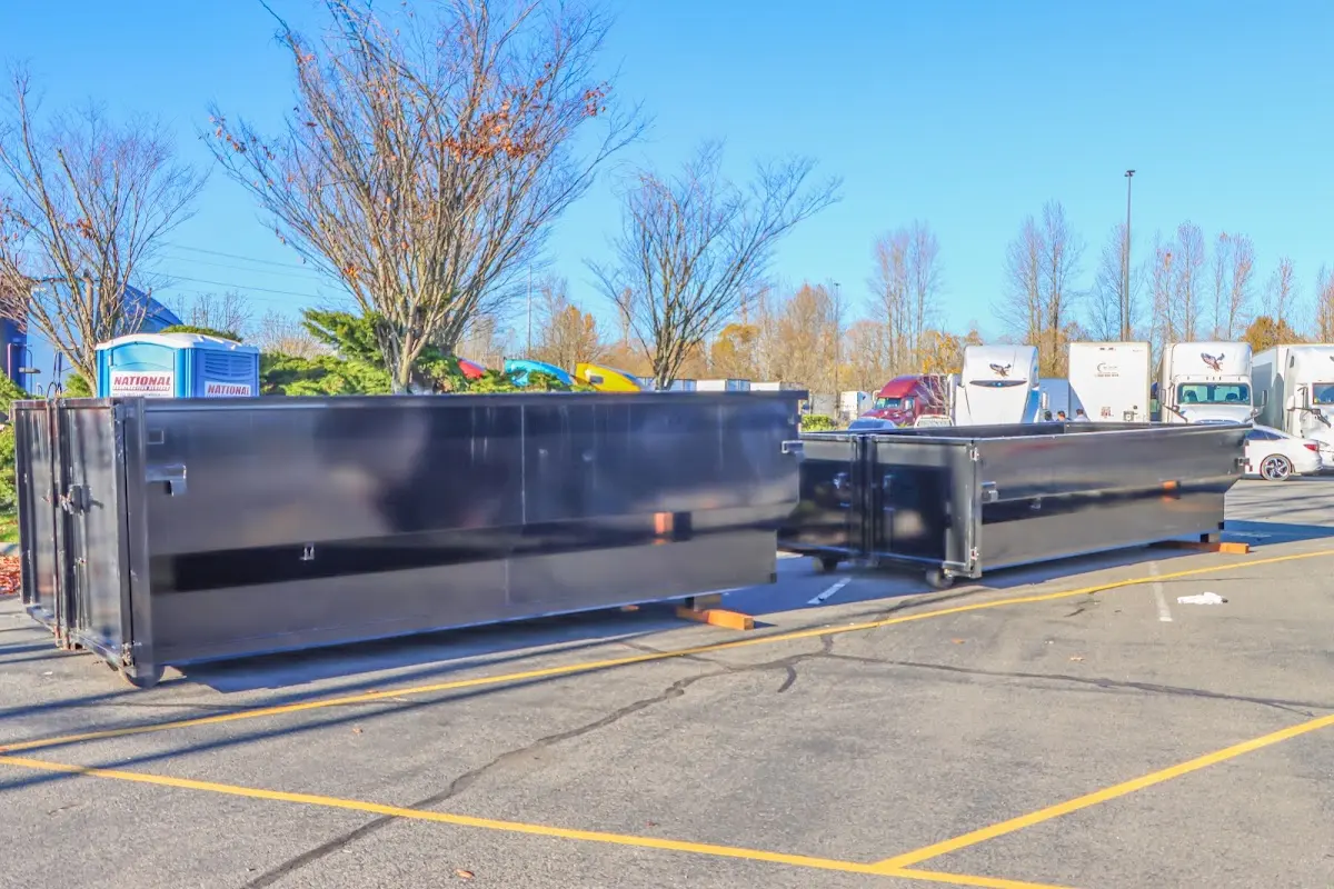 Professional dumpster rental service with roll-off container on residential driveway in Liberty